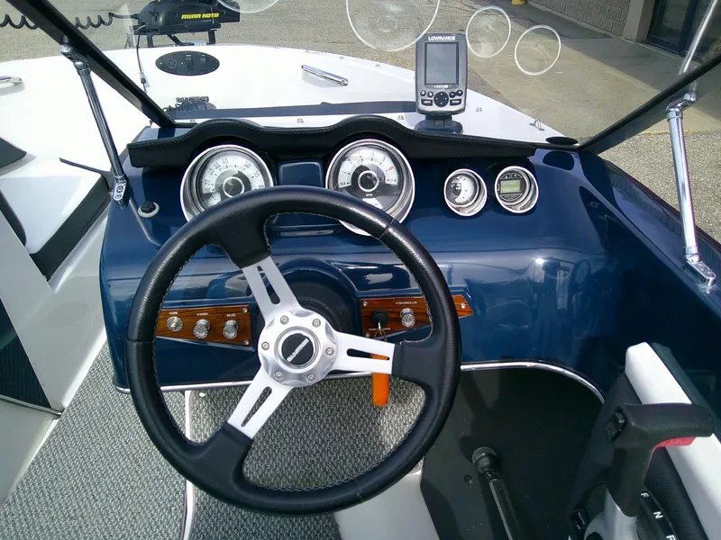 Slide: The Image of 2015 Glastron GT 180 Ski & Fish boat dashboard with steering wheel and gauges. - 11