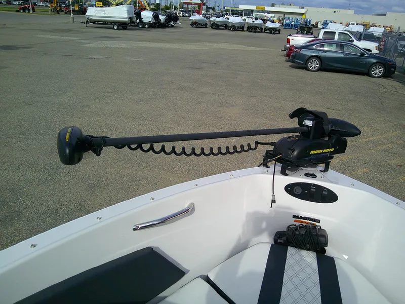 Slide: The Image of 2015 Glastron GT 180 Ski & Fish boat with Minn Kota trolling motor in a parking lot. - 13
