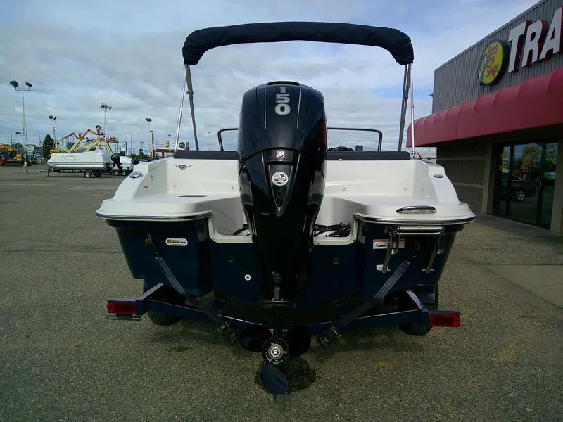 Slide: The Image of 2015 Glastron GT 180 Ski & Fish boat with outboard motor, parked outdoors. - 7