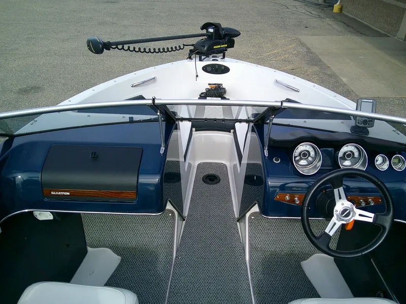 Slide: The Image of 2015 Glastron GT 180 Ski & Fish boat interior with steering wheel and dashboard controls. - 8