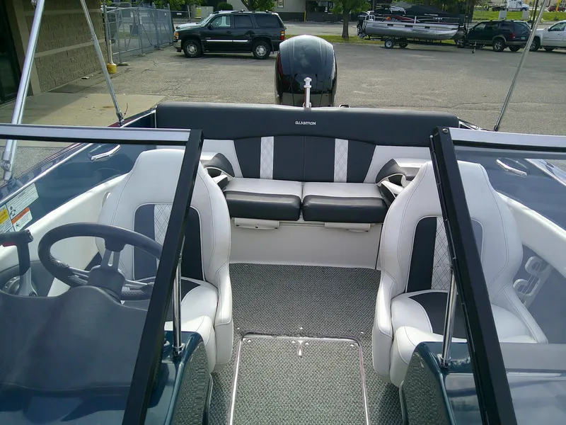 Slide: The Image of 2015 Glastron GT 180 Ski & Fish boat interior with seating and steering wheel. - 9