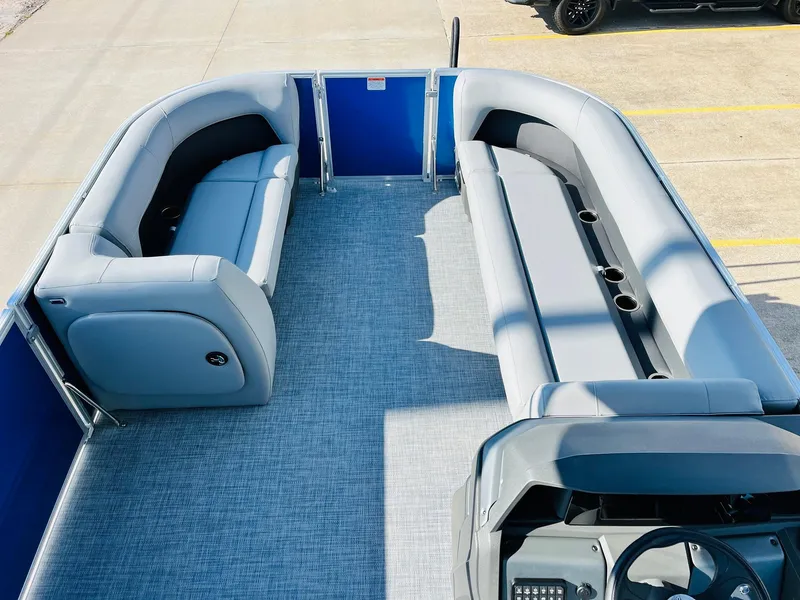 Slide: The Image of 2026 Sun Tracker Party Barge 18 DLX interior with gray seating and blue accents. - 11