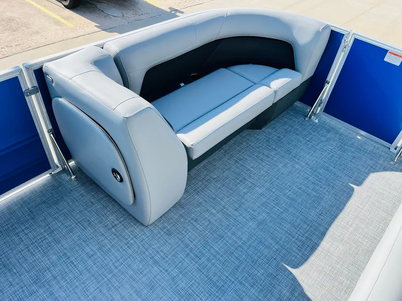 Slide: The Image of 2026 Sun Tracker Party Barge 18 DLX interior with gray seating and blue accents. - 12