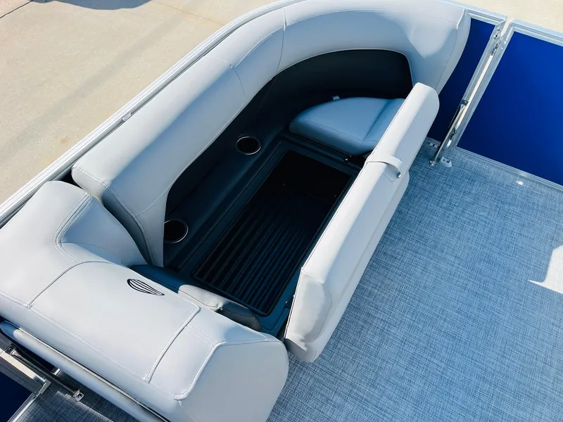 Slide: The Image of 2026 Sun Tracker Party Barge 18 DLX interior seating with storage and cup holders. - 15