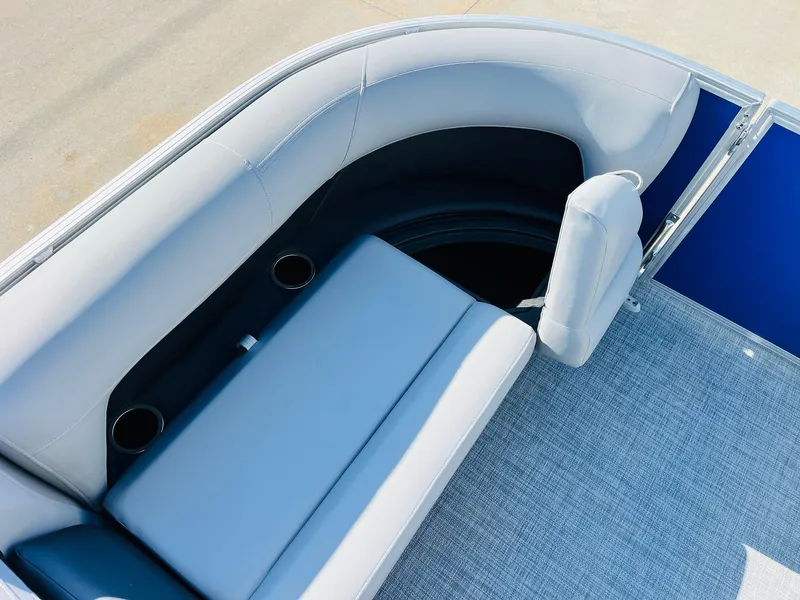 Slide: The Image of 2026 Sun Tracker Party Barge 18 DLX interior with cushioned seating and cup holders. - 16