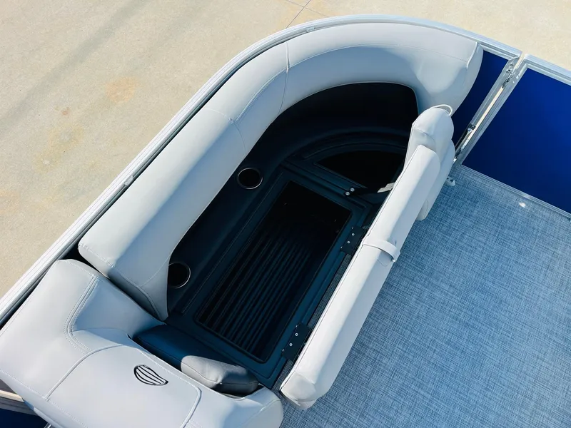 Slide: The Image of 2026 Sun Tracker Party Barge 18 DLX seating area with storage and cup holders. - 17