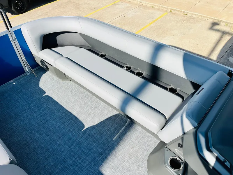 Slide: The Image of 2026 Sun Tracker Party Barge 18 DLX interior with gray seating and cup holders. - 18