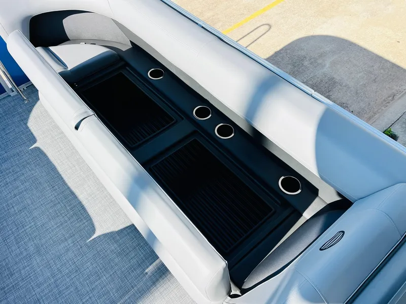 Slide: The Image of 2026 Sun Tracker Party Barge 18 DLX seating area with cup holders and storage. - 19