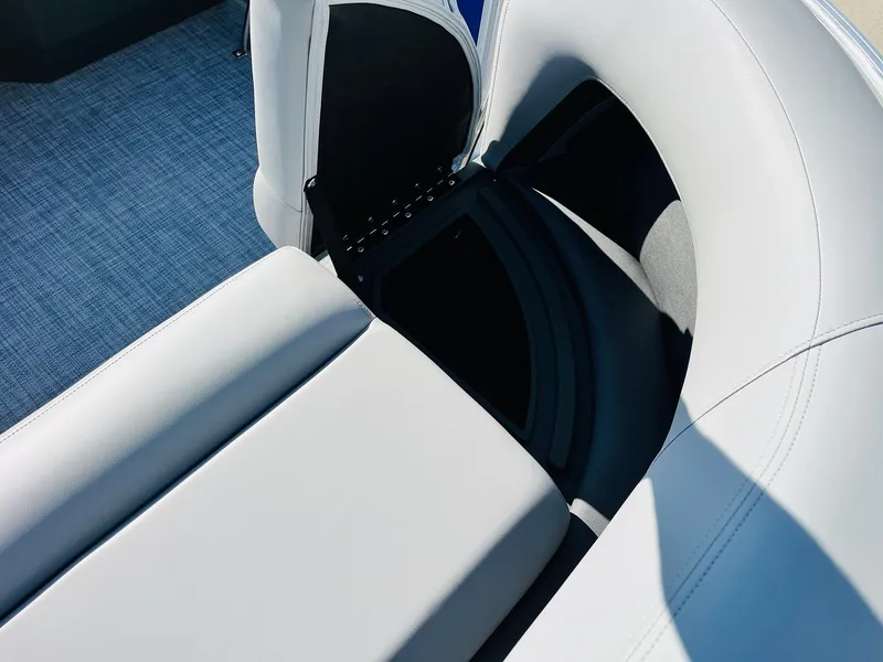 Slide: The Image of 2026 Sun Tracker Party Barge 18 DLX interior seating with storage compartment. - 20