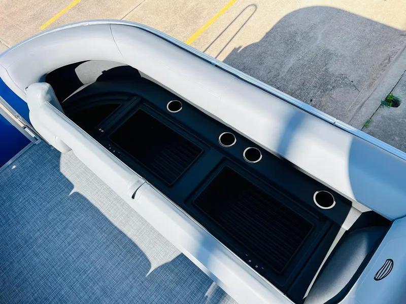 Slide: The Image of 2026 Sun Tracker Party Barge 18 DLX interior with seating and cup holders. - 21