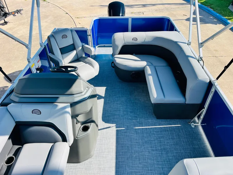Slide: The Image of 2026 Sun Tracker Party Barge 18 DLX interior with gray seating and blue accents. - 23