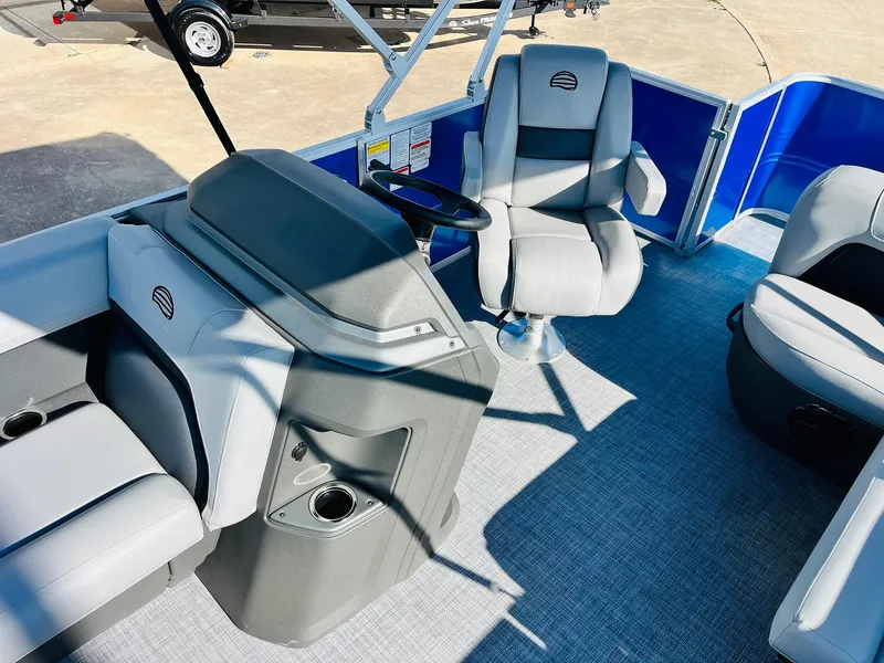 Slide: The Image of 2026 Sun Tracker Party Barge 18 DLX interior with modern seating and steering console. - 24