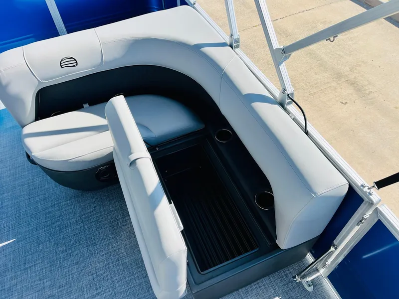 Slide: The Image of 2026 Sun Tracker Party Barge 18 DLX interior seating with storage and cup holders. - 28