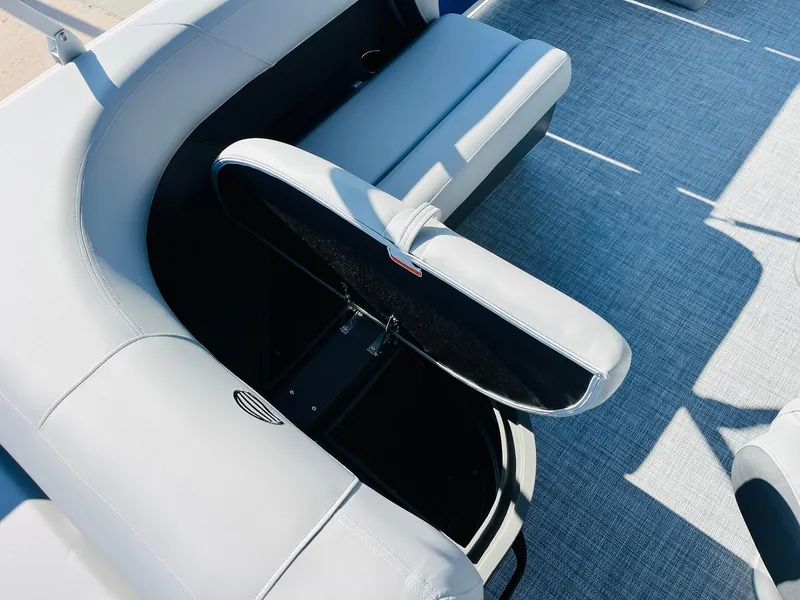 Slide: The Image of 2026 Sun Tracker Party Barge 18 DLX interior with open storage compartment and seating. - 29