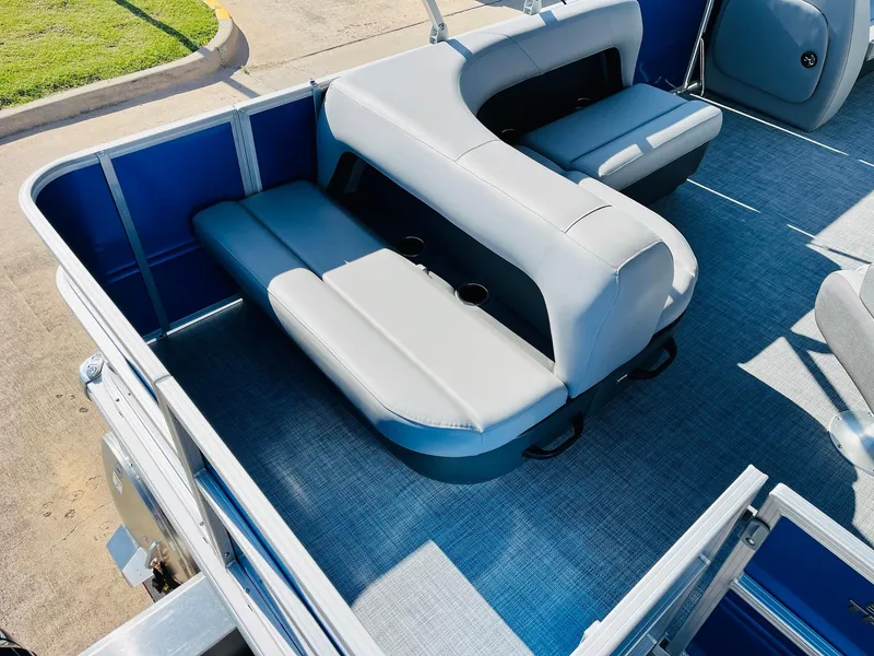Slide: The Image of 2026 Sun Tracker Party Barge 18 DLX interior with gray seating and blue accents. - 32