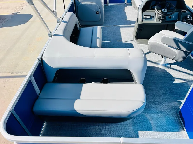Slide: The Image of 2026 Sun Tracker Party Barge 18 DLX interior with seating and steering console. - 33