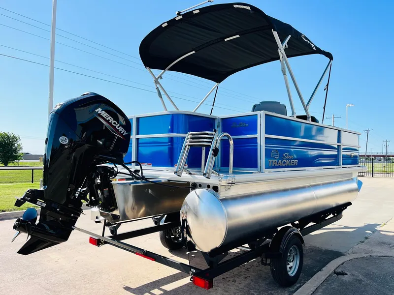 Slide: The Image of 2026 Sun Tracker Party Barge 18 DLX pontoon boat with Mercury engine on trailer. - 6