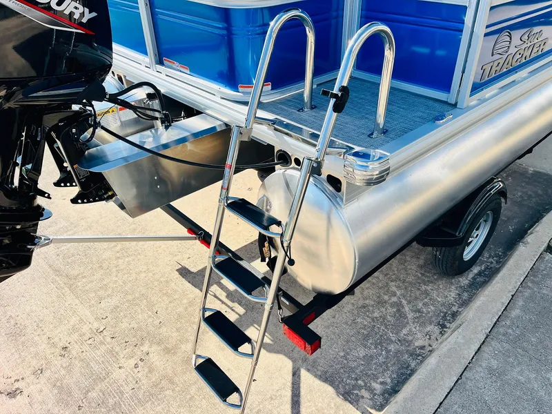 Slide: The Image of 2026 Sun Tracker Party Barge 18 DLX with ladder and Mercury outboard motor. - 9