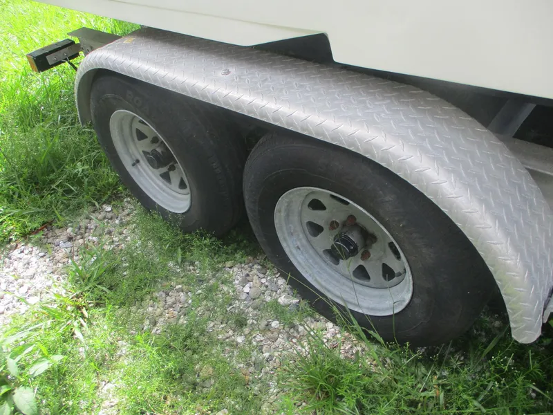 Slide: The Image of Trailer wheels of a 2008 Hydra-Sports 23 Bay Bolt on grass and gravel. - 18