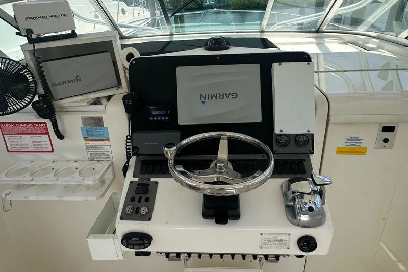 Slide: The Image of 2005 Rampage 30 Express helm with Garmin navigation and Standard Horizon equipment. - 10