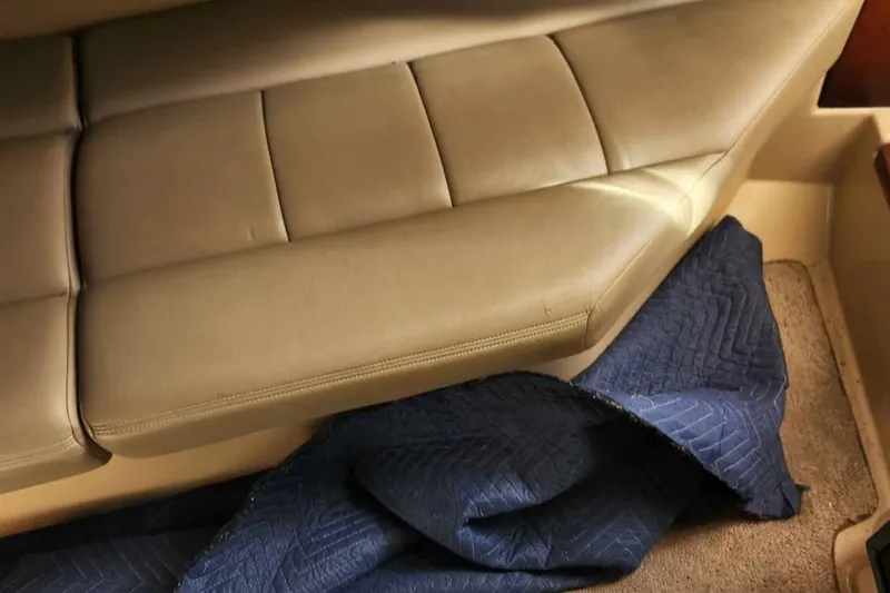 Slide: The Image of 2005 Rampage 30 Express interior with beige seating and blue quilted blanket. - 19
