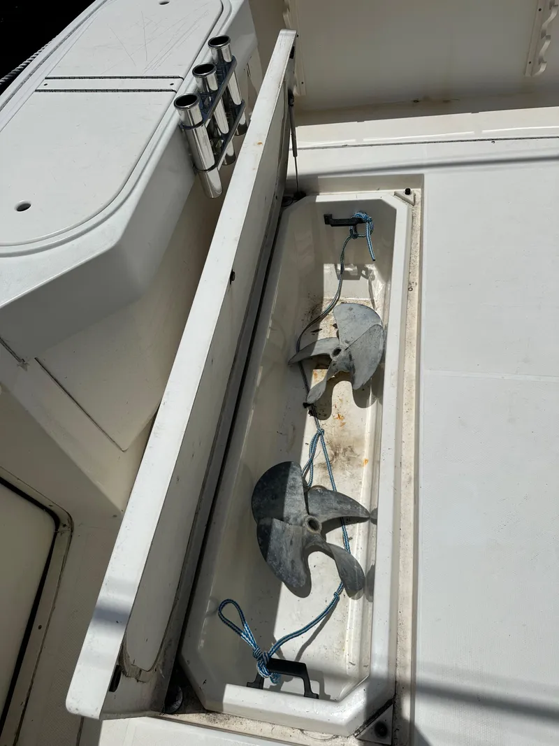 Slide: The Image of Storage compartment on 2005 Rampage 30 Express boat with anchors and fishing rod holders. - 2