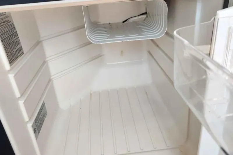 Slide: The Image of Empty refrigerator interior of a 2005 Rampage 30 Express boat. - 21