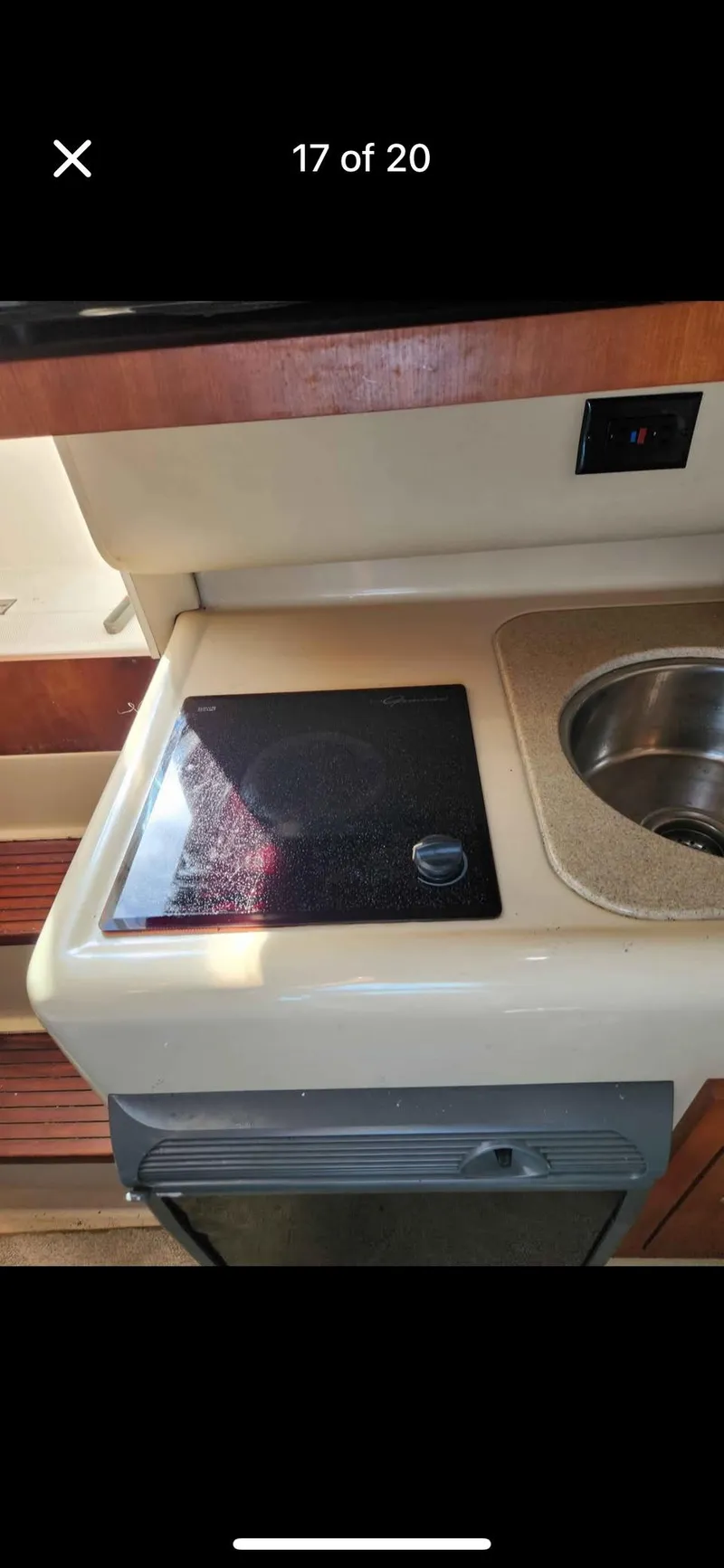 Slide: The Image of 2005 Rampage 30 Express boat kitchen with stove and sink. - 24