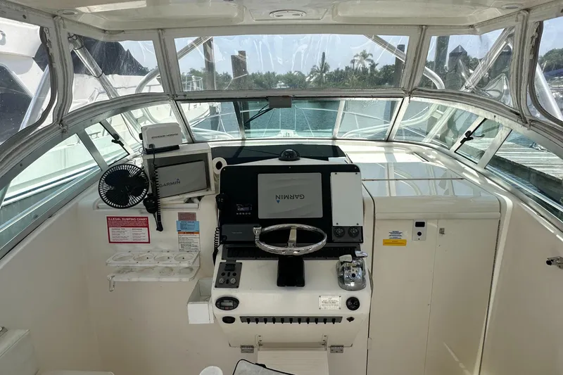 Slide: The Image of 2005 Rampage 30 Express helm with Garmin navigation system and steering wheel. - 9