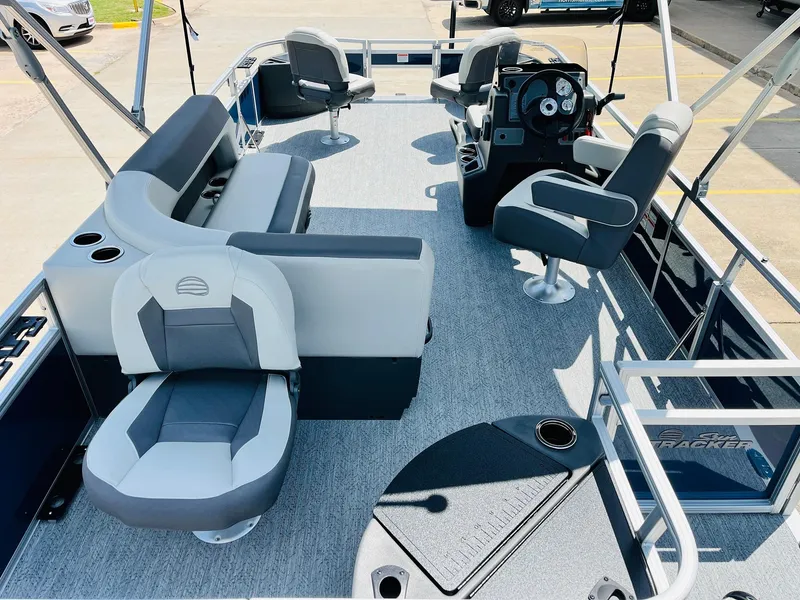 Slide: The Image of 2026 Sun Tracker Bass Buggy 18 DLX pontoon boat interior with seating and steering console. - 10