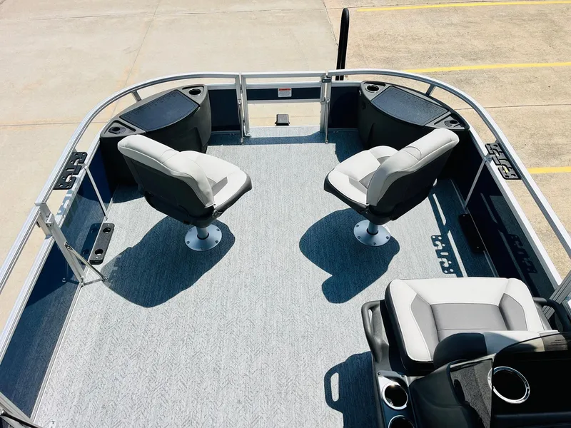 Slide: The Image of 2026 Sun Tracker Bass Buggy 18 DLX pontoon boat interior with seating and storage compartments. - 11