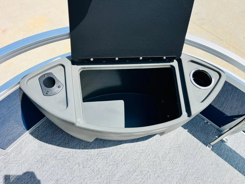 Slide: The Image of 2026 Sun Tracker Bass Buggy 18 DLX storage compartment with cup holder and speaker mount. - 13