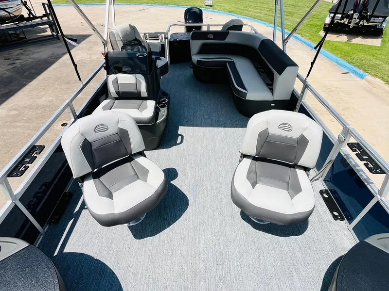 Slide: The Image of 2026 Sun Tracker Bass Buggy 18 DLX pontoon boat interior with seating and helm. - 16