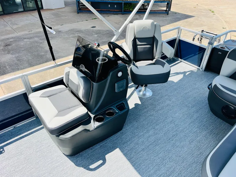Slide: The Image of 2026 Sun Tracker Bass Buggy 18 DLX interior with steering console and seating. - 17