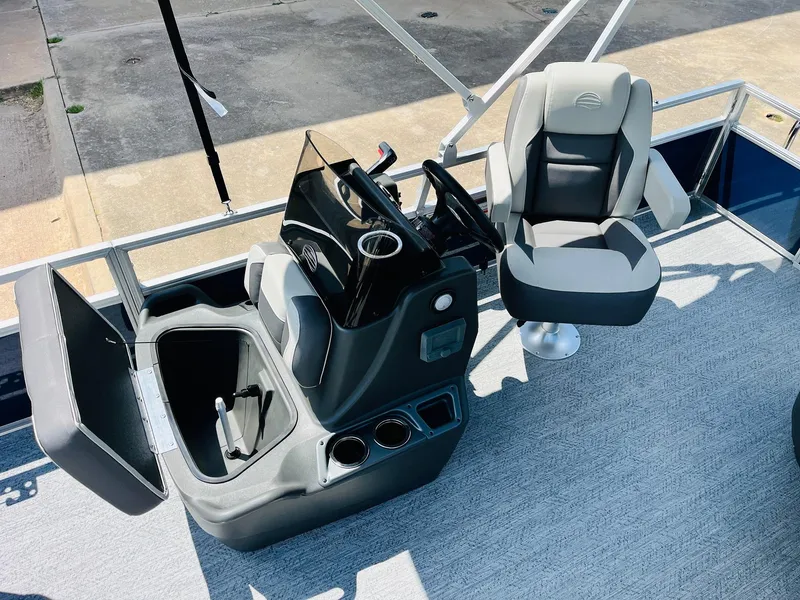 Slide: The Image of 2026 Sun Tracker Bass Buggy 18 DLX boat interior with helm and seating area. - 18