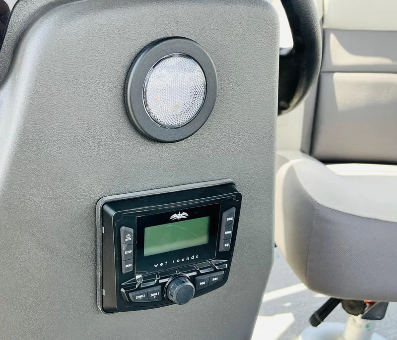 Slide: The Image of 2026 Sun Tracker Bass Buggy 18 DLX dashboard with Wet Sounds audio system and speaker. - 21