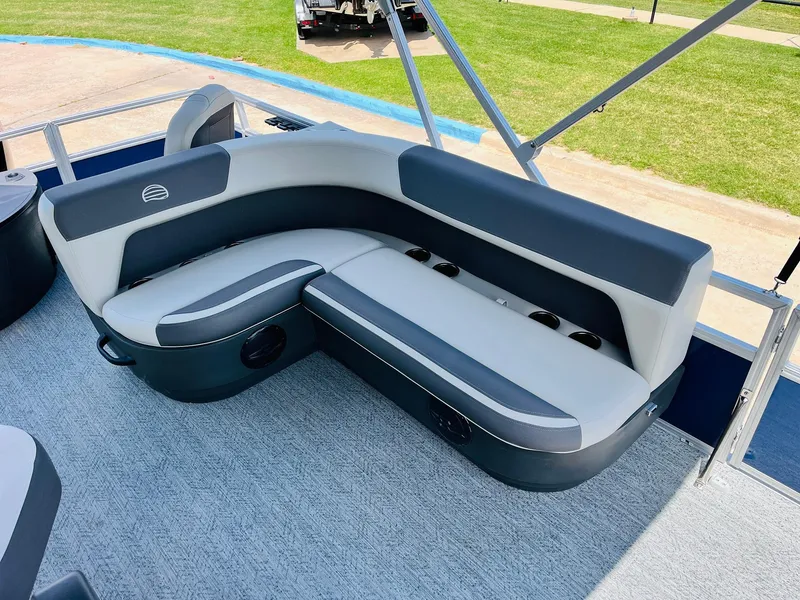 Slide: The Image of 2026 Sun Tracker Bass Buggy 18 DLX pontoon boat with gray seating and cup holders. - 23