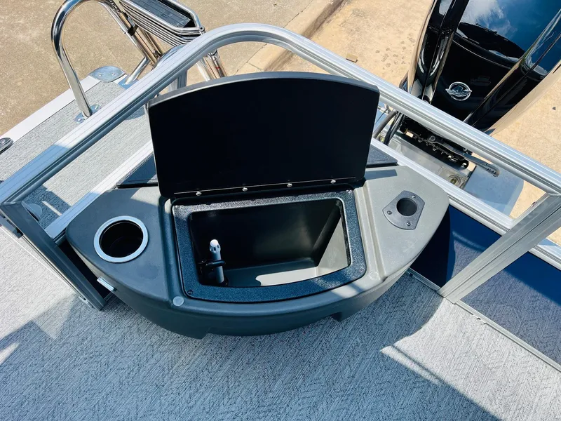 Slide: The Image of 2026 Sun Tracker Bass Buggy 18 DLX boat with open storage compartment and cup holder. - 32