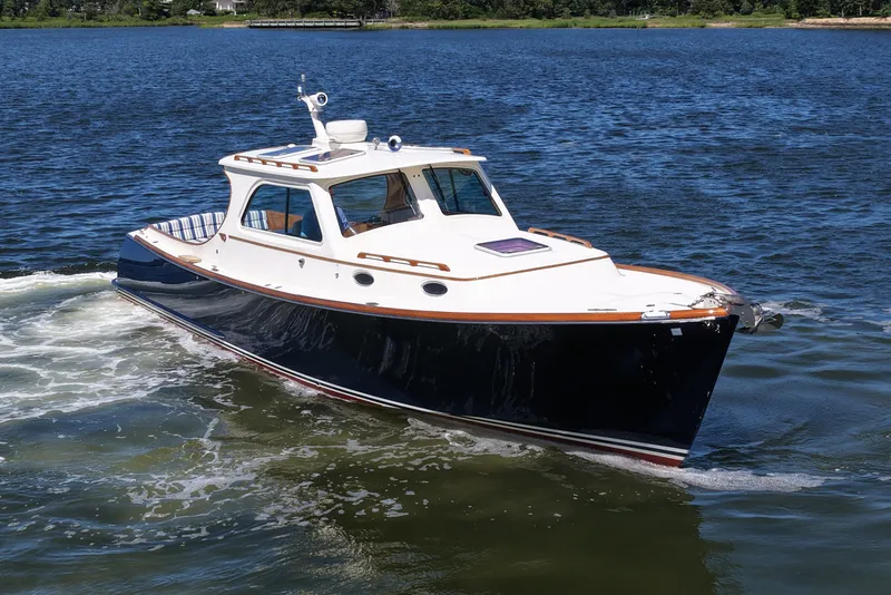 Slide: The Image of 2005 Hinckley 36 boat cruising on a calm lake. - 13