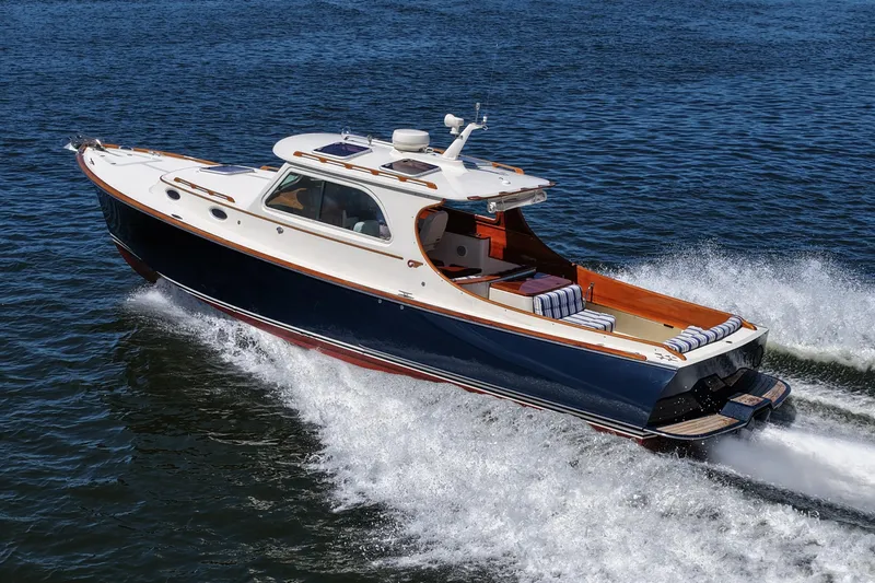 Slide: The Image of Hinckley 36 yacht cruising on water, 2005 model, elegant design, blue and white exterior. - 18