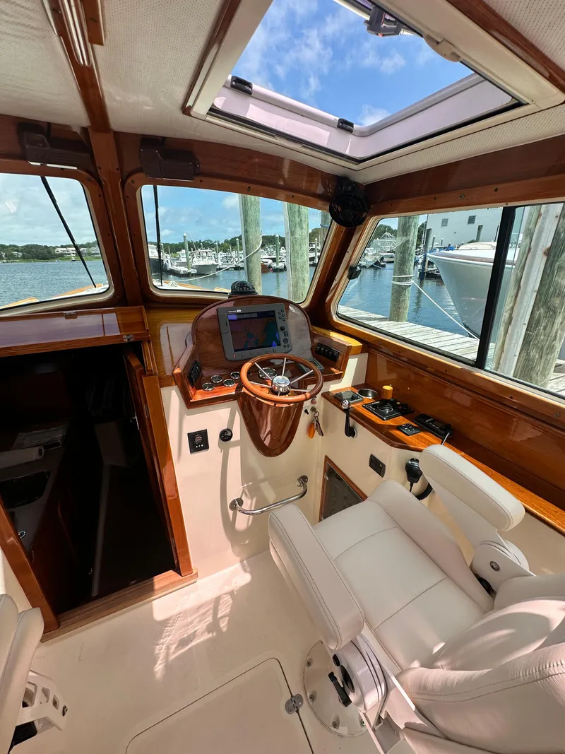 Slide: The Image of Interior of 2005 Hinckley 36 boat cockpit with steering wheel and navigation equipment. - 25