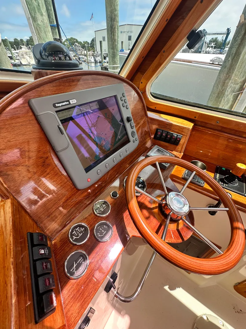 Slide: The Image of Helm of 2005 Hinckley 36 boat with wooden steering wheel and navigation system. - 26