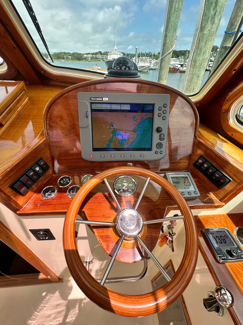 Slide: The Image of Helm of 2005 Hinckley 36 boat with navigation system and wooden steering wheel. - 27