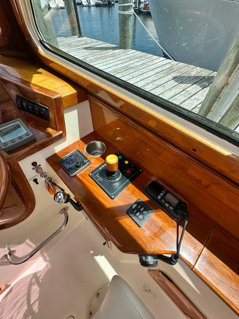 Slide: The Image of Helm of 2005 Hinckley 36 boat with wooden dashboard and control instruments. - 29