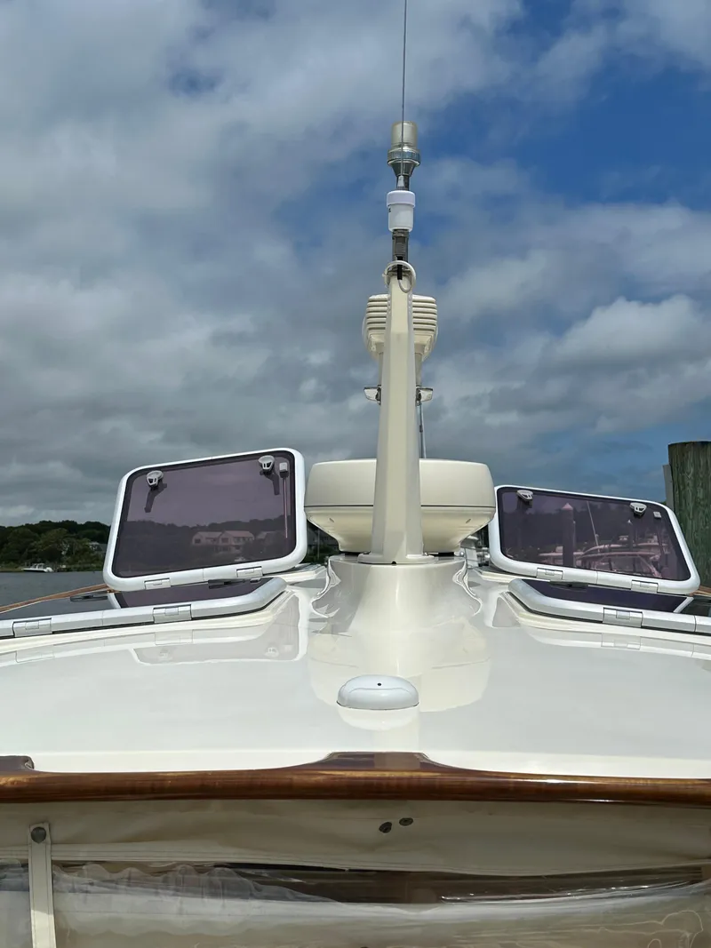 Slide: The Image of 2005 Hinckley 36 boat deck with hatches, under a partly cloudy sky. - 30