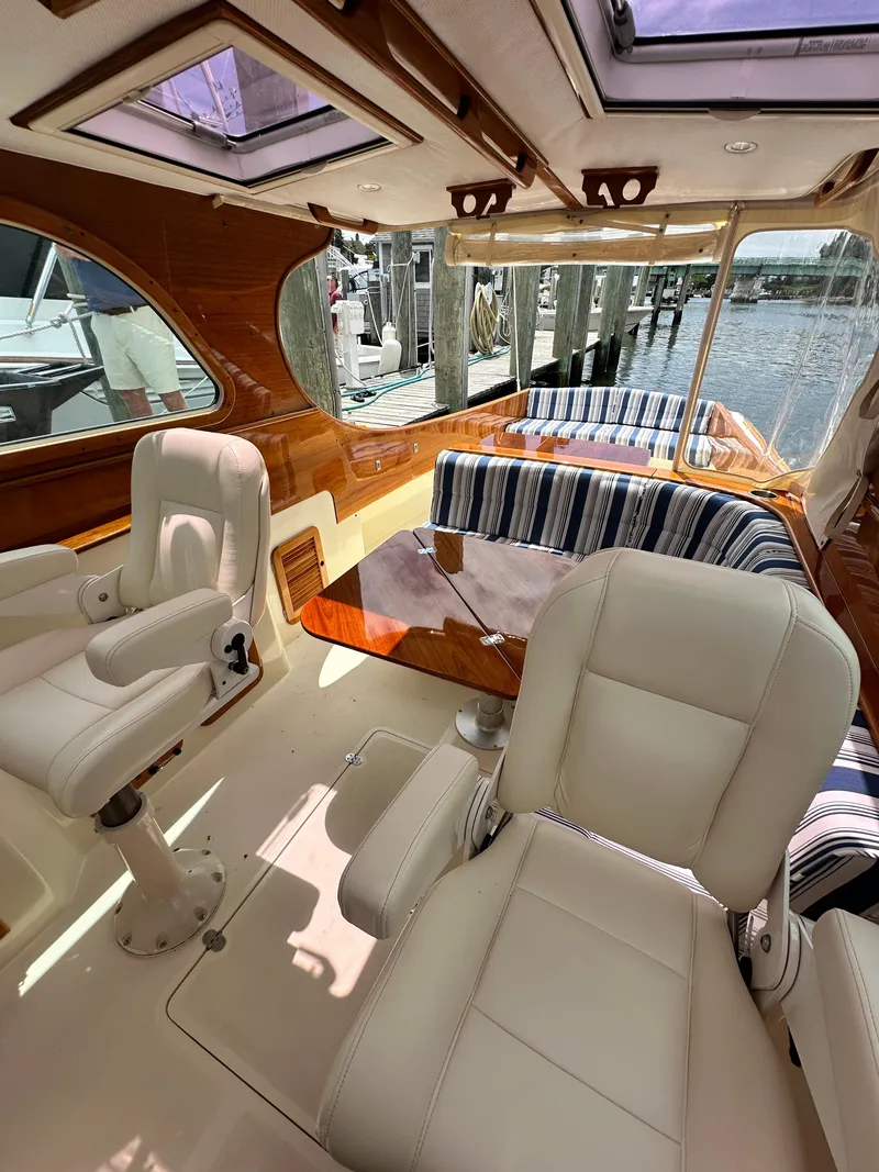 Slide: The Image of Interior of a 2005 Hinckley 36 boat with white seats and striped cushions. - 33