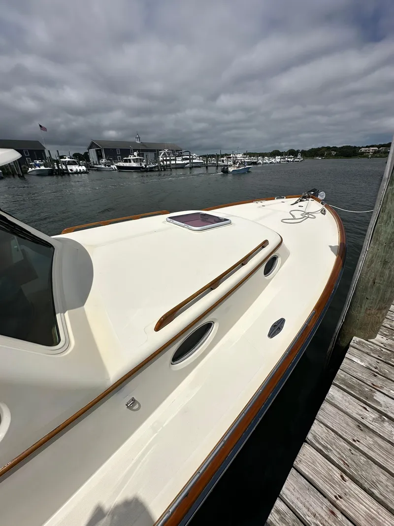 Slide: The Image of 2005 Hinckley 36 boat docked at marina under cloudy sky. - 45