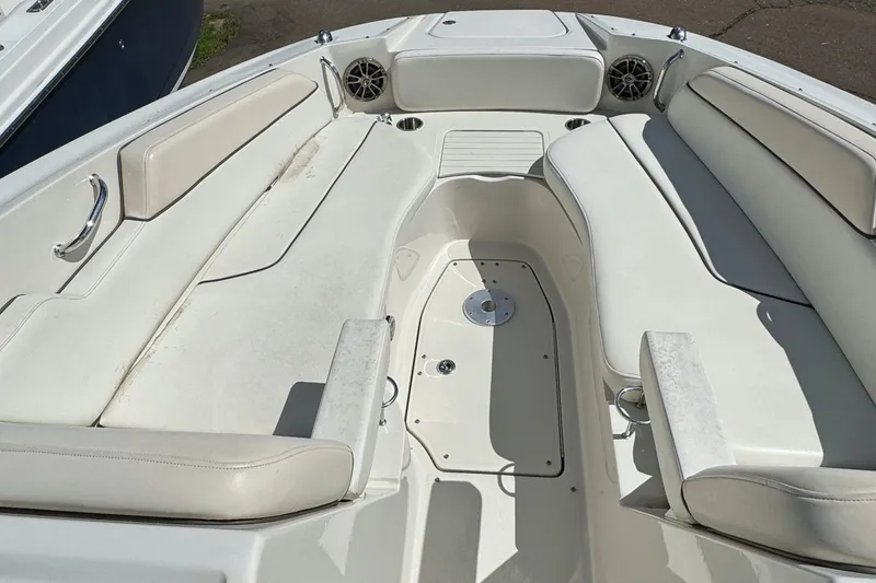 Slide: The Image of 2008 Sea Ray 290 Sundeck boat interior with white seating and speakers. - 6