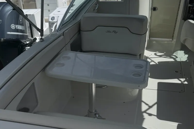 Slide: The Image of 2008 Sea Ray 290 Sundeck interior with seating and table, featuring Yamaha engine in background. - 9