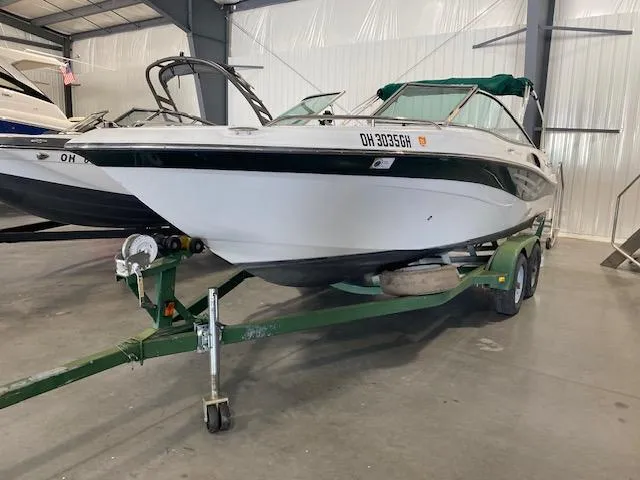 Slide: The Image of 2000 Four Winns 210 Horizon boat on trailer in indoor storage facility. - 2